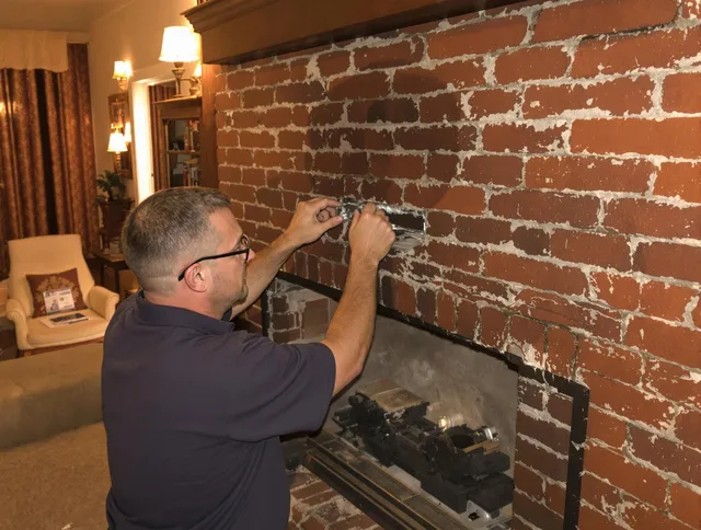 Huntington Beach Chimney Sweep expert fixing a fireplace in Huntington Beach, CA